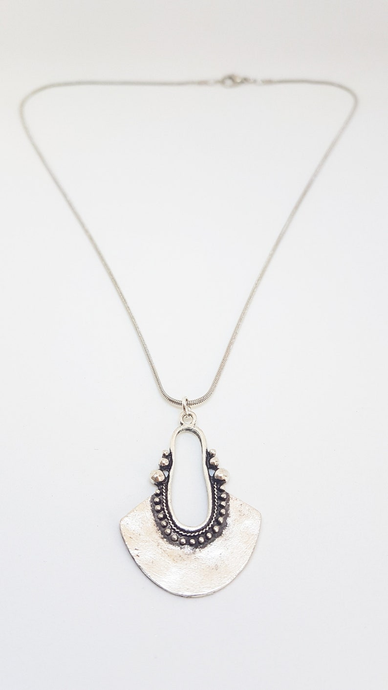 Silver necklace with tibetan charm