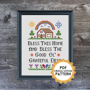 May include: A framed cross-stitch pattern with the text "BLESS THIS HOME AND BLESS THE GOOD OL' GRATEFUL DEED." The design includes a house, rainbow, sun, trees, and flowers. A sticker reads "PDF CROSS STITCH PATTERN."