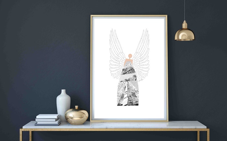 May include: A framed print of a black and white illustration of an angel with wings. The angel is wearing a dress made of a collage of different patterns. The background is white.