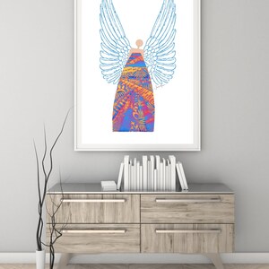 May include: A framed print of a colourful angel with blue wings and a patterned dress. The angel is standing on a white background.