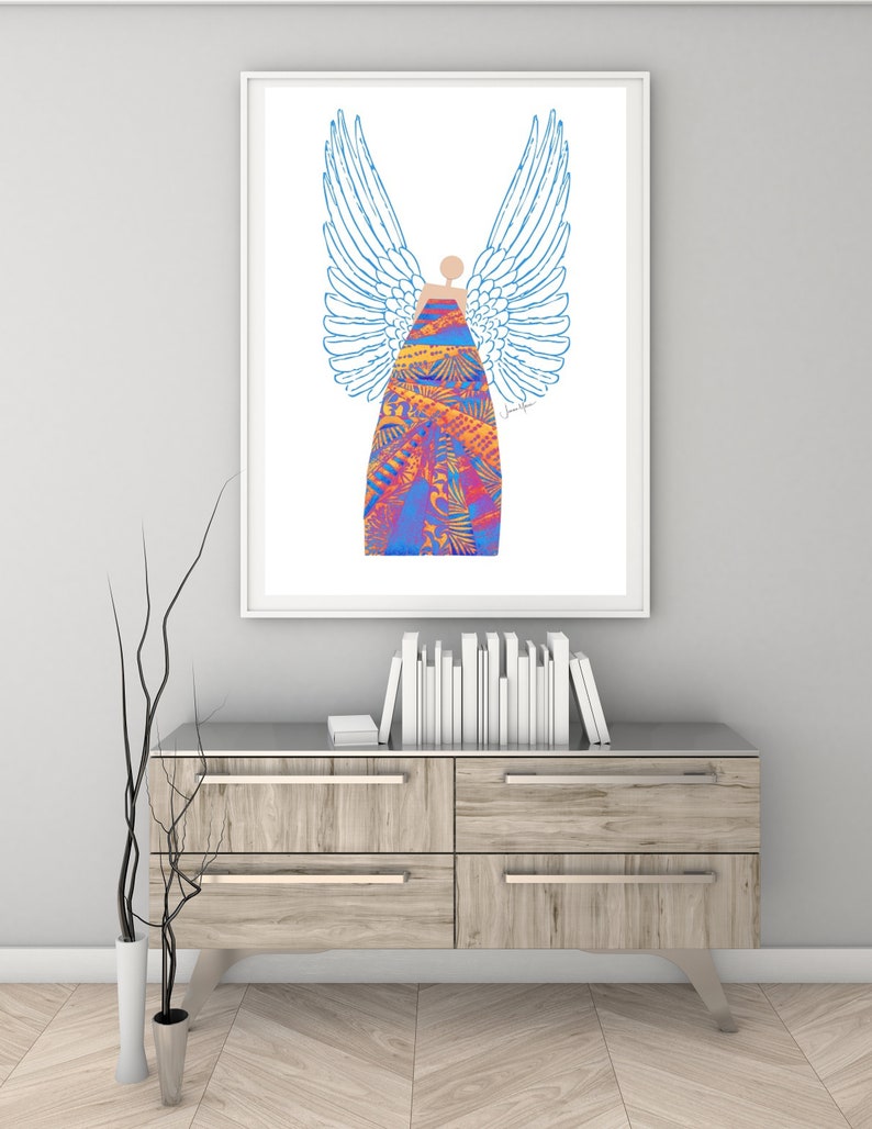 May include: A framed print of a colourful angel with blue wings and a patterned dress. The angel is standing on a white background.