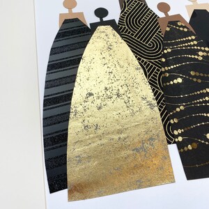 May include: A framed art piece featuring five figures with black, gold, and brown paper cutouts. The figures are wearing different patterned dresses, including stripes, geometric designs, and polka dots.