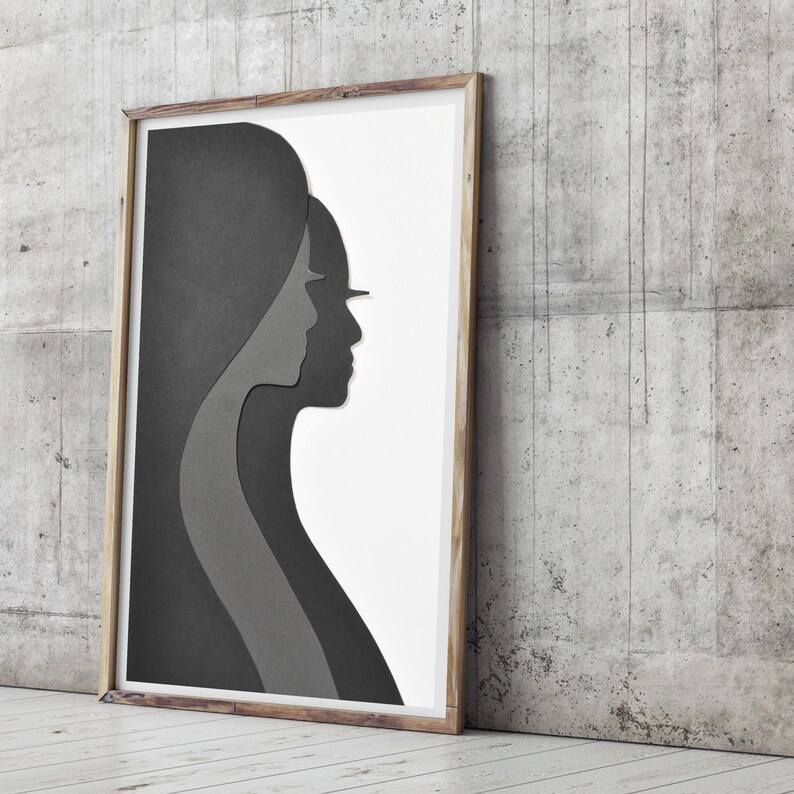 May include: A framed black and white print of two faces in profile, one behind the other, creating a layered effect.