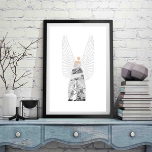 May include: A black and white illustration of an angel with wings, wearing a dress with a geometric pattern. The illustration is framed and displayed on a white brick wall.