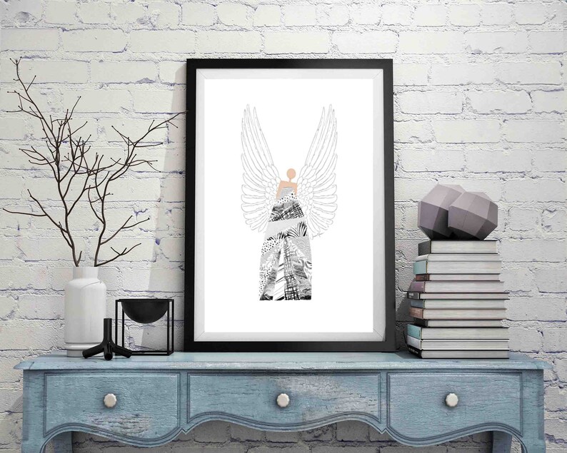 May include: A black and white illustration of an angel with wings, wearing a dress with a geometric pattern. The illustration is framed and displayed on a white brick wall.