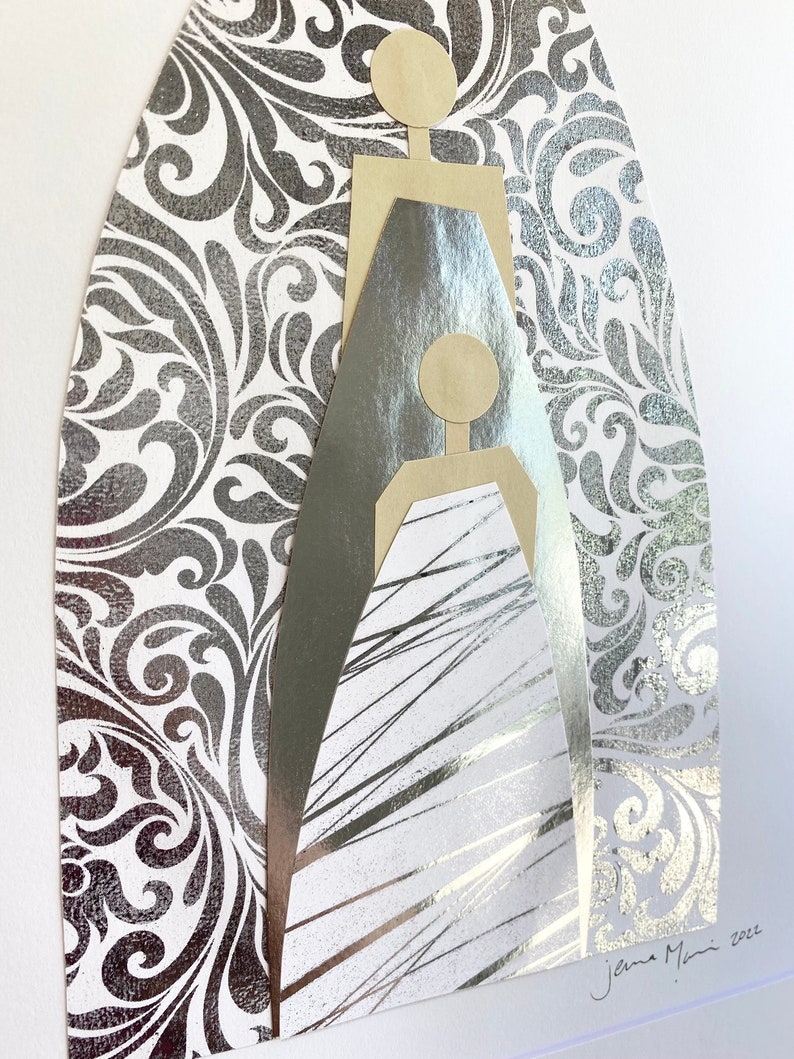 May include: A silver and gold abstract art piece with a geometric design. The piece is set against a silver damask background. The artist's signature, "Jana Mani 2022", is in the bottom right corner.