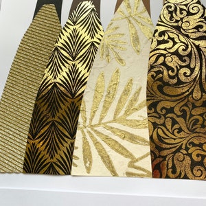 May include: Four abstract figures with black silhouettes and gold patterned dresses. The dresses feature different patterns, including stripes, leaves, and swirls.
