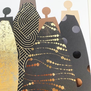 May include: Five paper cutouts of figures in black dresses with gold and copper accents. The dresses have different patterns, including geometric shapes, polka dots, and a beaded design.