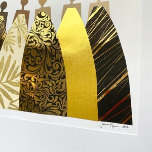 May include: A framed collage of seven figures in gold and black, each wearing a different patterned gown. The artwork is signed "Jenna Marin 2022" in the bottom right corner.