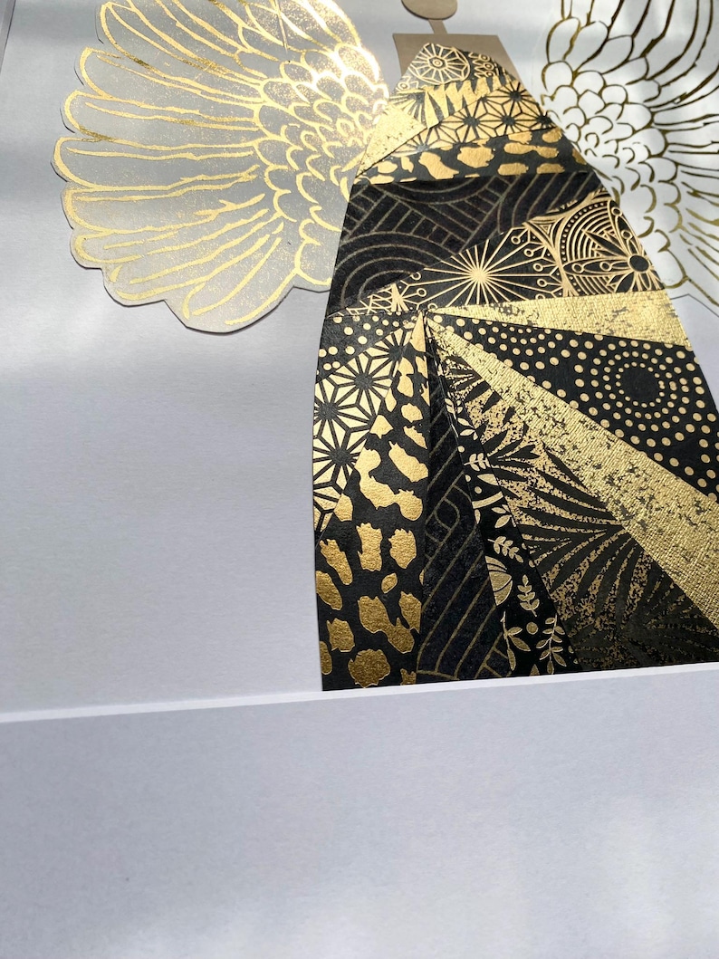 May include: An abstract art print in black and gold, depicting a stylised figure with wings. The figure is composed of geometric shapes and patterns, including circles, stars, and animal print.