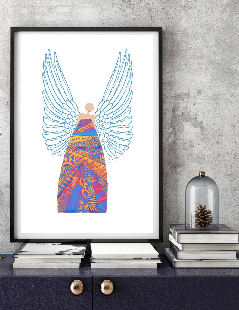 May include: A digital art print of an angel with blue wings and a colourful patterned dress. The print is framed in a black frame and is hanging on a wall.