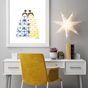 May include: A framed print of a watercolor illustration of two figures wearing patterned dresses. The dress on the left is blue and white, and the dress on the right is yellow and white. The print is hanging on a white wall above a white desk with a yellow chair.