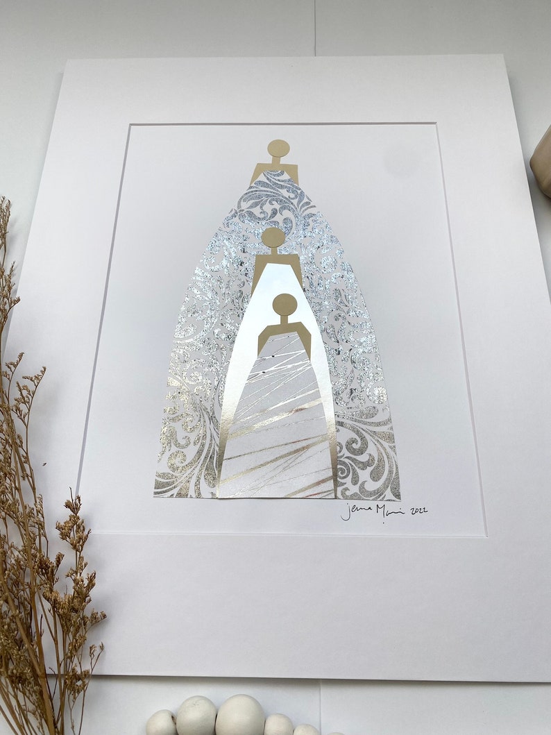 May include: A white matted print with a gold and silver abstract design of three figures. The figures are layered on top of each other and are surrounded by a silver patterned background. The print is signed "Jenna Mani 2022" in the bottom right corner.