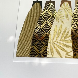 May include: Five abstract figures in a row, each with a different gold patterned dress. The figures are cut out of paper and mounted on a white background.