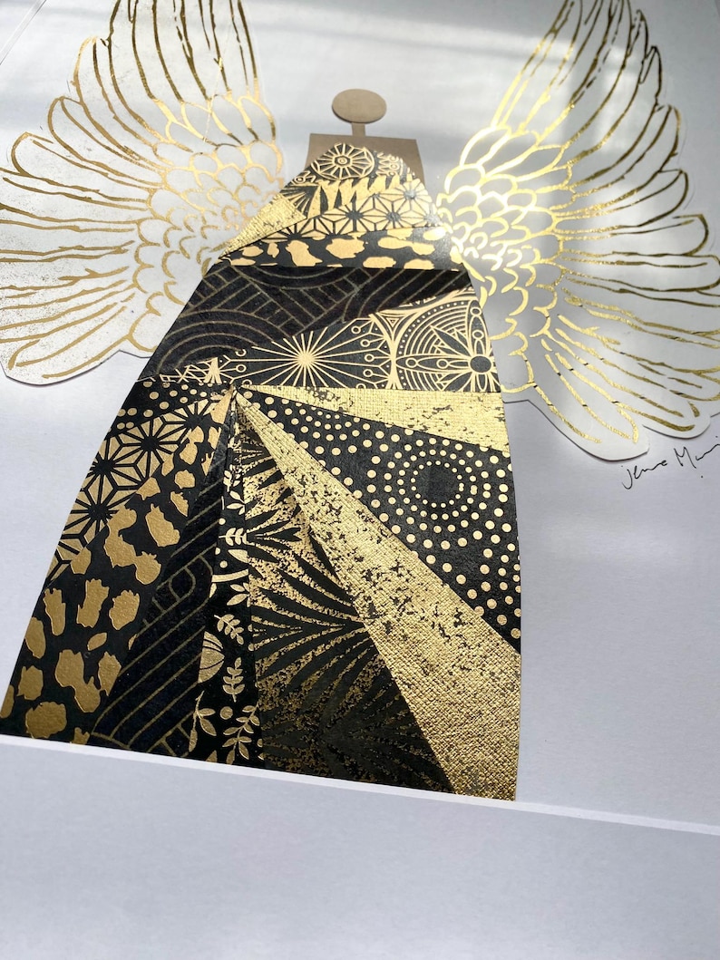 May include: A black and gold angel with wings made of gold leaf. The angel's body is made of a patchwork of different black and gold patterns. The angel is signed "Jeno Mai" in the bottom right corner.