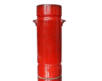 May include: A red ceramic vase with two small handles on the sides. The vase has a glossy finish.