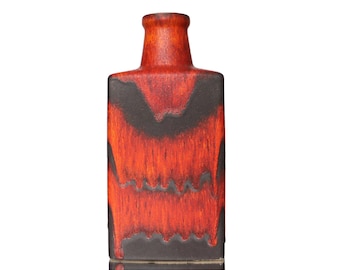 May include: A red and black ceramic vase with a rectangular body and a narrow neck. The vase has a unique, abstract design with flowing lines and a mottled glaze.