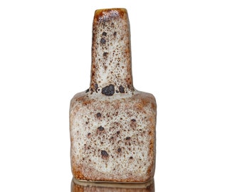 May include: A brown and white ceramic vase with a speckled glaze. The vase has a square base and a tall, narrow neck.