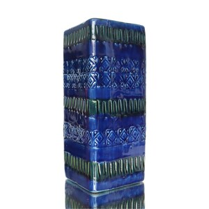 May include: A rectangular ceramic vase with a glossy deep blue glaze. The surface features horizontal bands of embossed geometric patterns, including repeating diamond shapes and vertical lines, creating a textured relief across the entire body.