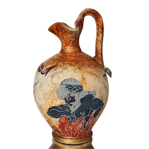 May include: A ceramic pitcher with a brown and white glaze. The pitcher has a handle and a round body. The pitcher is decorated with a black and white illustration of a mythical creature.