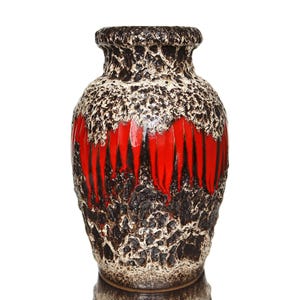 May include: A vintage ceramic vase with a textured surface. The vase features a striking design with a combination of black, white, and red colours. The red section has vertical black lines. The vase has a wide body and a narrow neck.