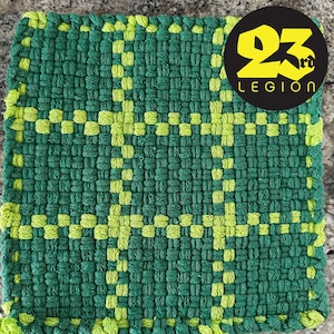 May include: Green and yellow woven kitchen pot holder with a black and yellow logo that says "23rd Legion".