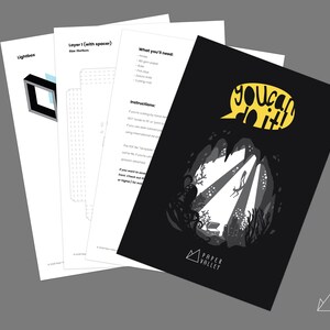 May include: A black and white papercraft design with the words "You can do it!" in a yellow speech bubble. The design features an underwater scene with an octopus, coral, and a diver. The design is from Paper Valley.