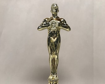 May include: Gold-colored trophy statuette of a person holding a heart. The statuette is on a black base with a gold plaque that reads "Make Someone Happy!!! CUSTOMIZE YOUR OWN MESSAGE on this Trophy Statuette"