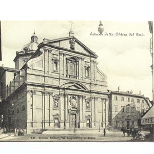May include: A black and white vintage postcard depicting the exterior of a church in Rome, Italy. The text on the postcard reads "Esterno della Chiesa del Gesu. Roma."
