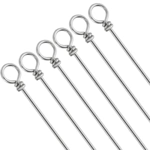 May include: Six stainless steel cocktail stirrers. Each stirrer has a looped end and a long, thin stem. The looped ends are tightly wound with wire. The stirrers are arranged diagonally against a white background.