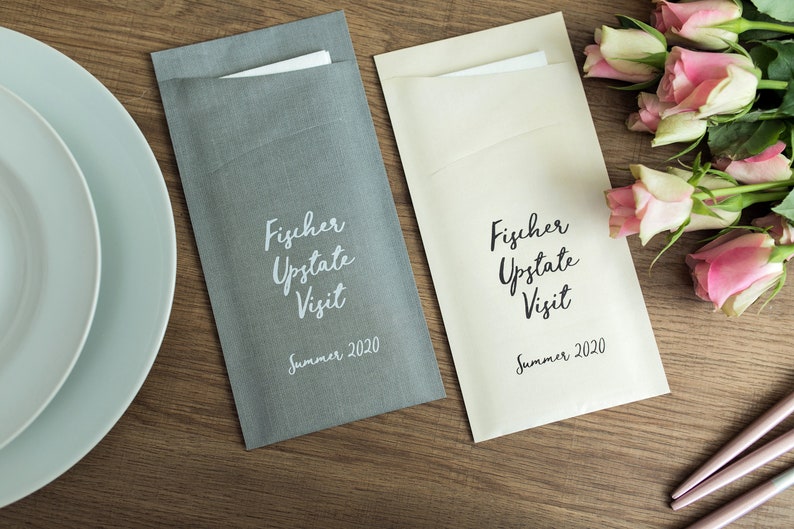 May include: Two gray and cream linen envelopes with the text "Fischer Upstate Visit Summer 2020" printed on them.