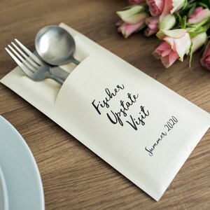 May include: A white paper envelope with a black inscription that reads "Fischer Upstate Visit Summer 2020". A fork and spoon are tucked inside the envelope.