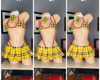 May include: Three mannequins wearing a yellow and black plaid skirt, a red and yellow bikini top, and a red halter top. The mannequins are numbered 1, 2, and 3.