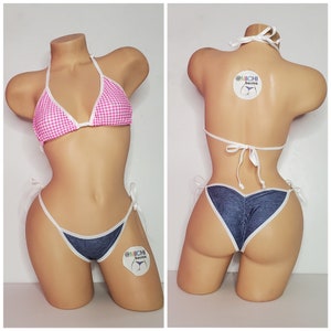 May include: Pink and white gingham bikini top with a matching denim bikini bottom. The bikini bottom has a white trim and is tied at the sides. The bikini top has adjustable straps and a triangle shape. The bikini is displayed on a mannequin.