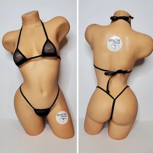 May include: Black mesh bikini set featuring a halter top and a thong bottom. The bikini is displayed on a mannequin. The bikini is crafted from a fine mesh fabric and has a delicate, feminine aesthetic.