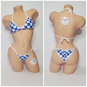 May include: Blue and white checkered bikini set with white ties. The bikini top is a triangle style and the bottom is a cheeky style. The bikini set has a tag that says "@Michi Bikinis".