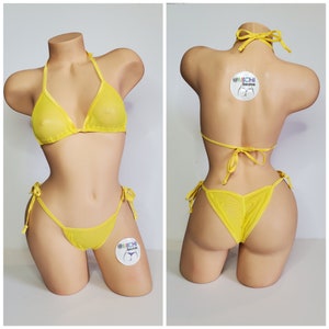 May include: Yellow mesh bikini with a halter top and a tie-side bottom. The bikini is on a mannequin. The bikini has a small logo tag on the bottom that says "@MICHI bikinis".