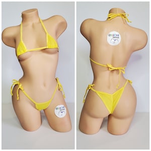 May include: Yellow bikini set with a triangle top and a string bottom. The bikini is made of a sheer, mesh fabric. The bikini is shown on a mannequin.