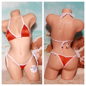 May include: Orange satin bikini with white trim. The top and bottom have adjustable ties. The bikini is on a mannequin.