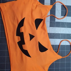 Bright Orange with Black Jack O Lantern Crop Top One Size (SMALL)