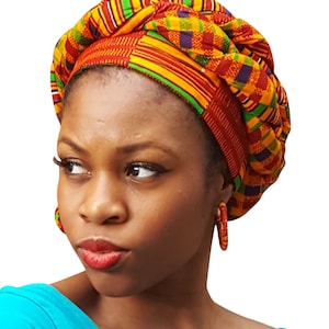 May include: A woman wearing a colorful head wrap with a red, yellow, green, and purple pattern. She is wearing a turquoise shirt and large hoop earrings.