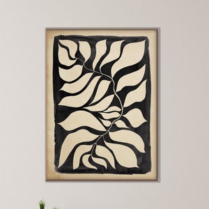 May include: Black and white abstract art print of stylized leaves. The print is framed and hanging on a white wall above a wooden console table.