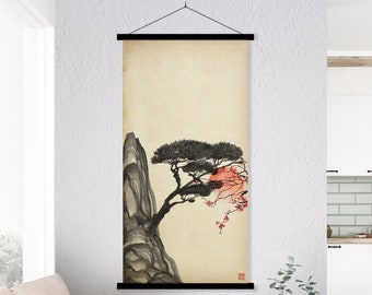 May include: A black and white illustration of a tree growing out of a rock with pink flowers. The illustration is on a beige background and is framed with a black wooden frame.