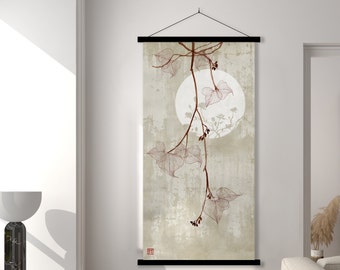 May include: A beige tapestry with a black frame hangs on a white wall. The tapestry features a delicate illustration of a vine with leaves and small red berries against a light beige background. A white circle with a subtle pink hue is visible in the center of the tapestry.