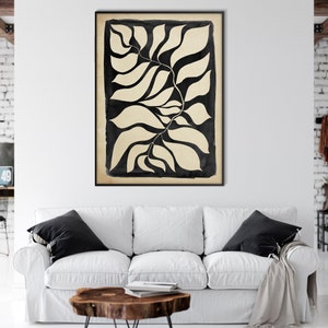 May include: Black and white abstract art print featuring a stylized image of leaves. The leaves are outlined in black and filled in with a cream color. The print has a vintage, hand-drawn aesthetic.