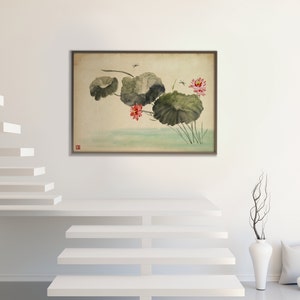 May include: A framed watercolor painting depicts lotus flowers and leaves in a serene pond setting. The artwork features large, green lily pads, vibrant pink flowers, and delicate dragonflies. The painting is set against a neutral background, creating a calming aesthetic.