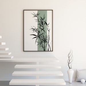 May include: A framed black and white illustration of bamboo plants with a green background. The illustration is hanging on a white wall above a set of white stairs.