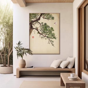 Pode incluir: Uma obra de arte emoldurada retratando uma pintura de estilo japon&ecirc;s de um galho de pinheiro com p&aacute;ssaros. A obra de arte apresenta um fundo neutro, um tronco de &aacute;rvore marrom e folhagem verde. Os p&aacute;ssaros s&atilde;o marrons e brancos.