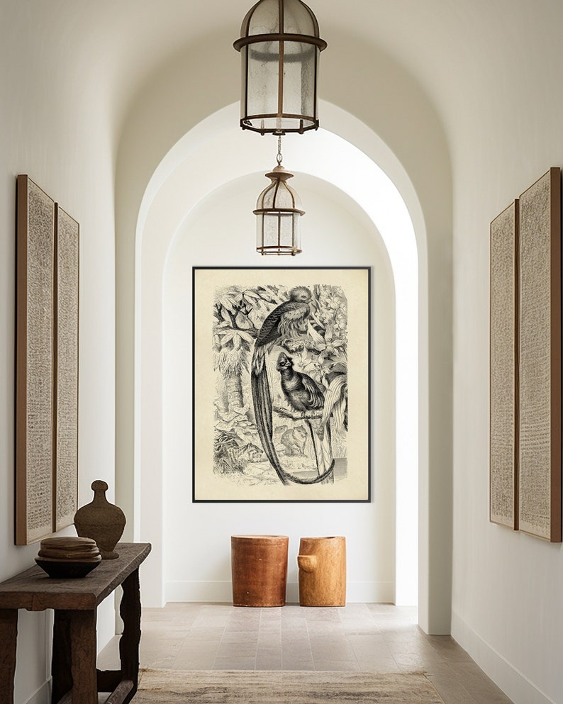 May include: A hallway with white walls and an arched doorway. A black and white print of two birds in a tree hangs on the wall. Two wooden stools are in front of the print. A wooden table with a vase and plates sits on the left side of the hallway.