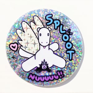 May include: A round, glittery badge featuring a white cartoon creature with wings, a heart, and the text "SPLOOT" and "NUUUUU!!" in blue and purple. The background is silver with iridescent glitter.